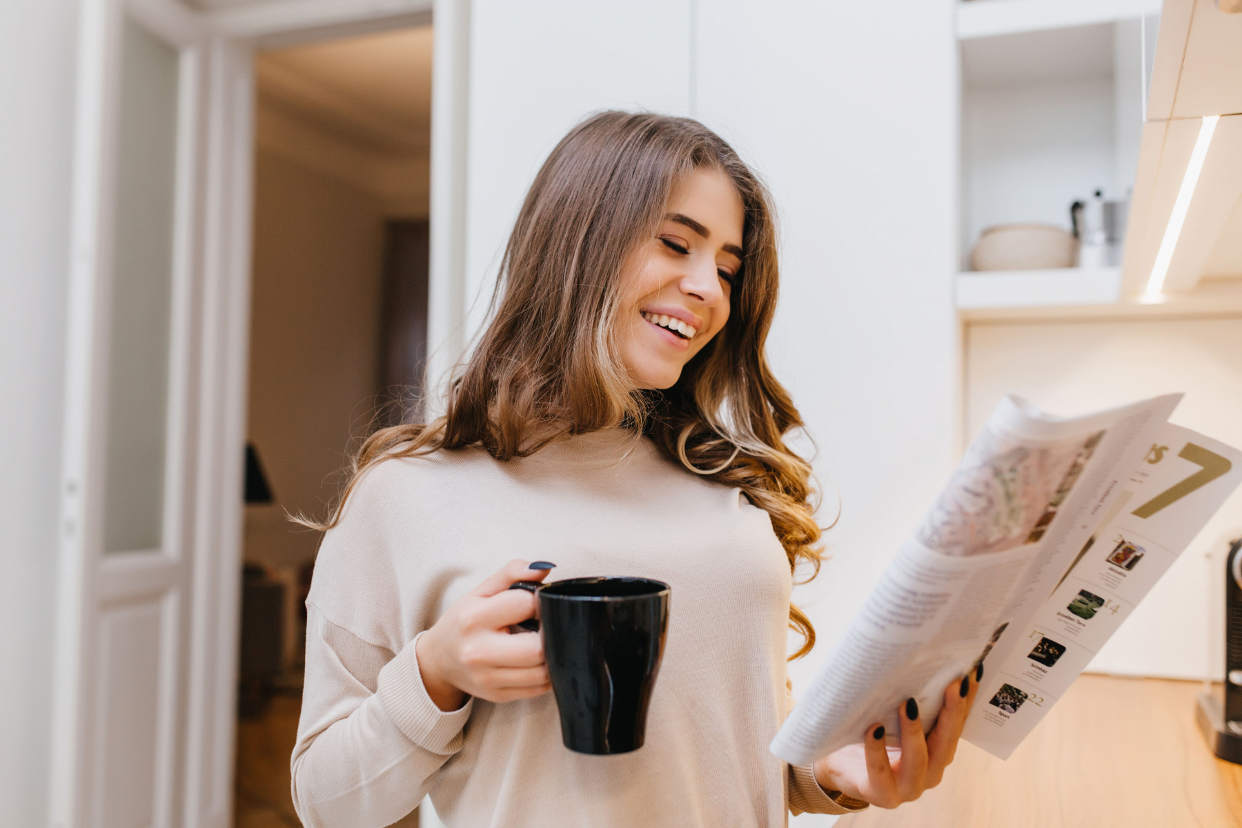 glad-white-woman-beige-attire-reading-news-kitchen-while-drinking-coffee.jpg glad-white-woman-beige-attire-reading-news-kitchen-while-drinking-coffee.jpg