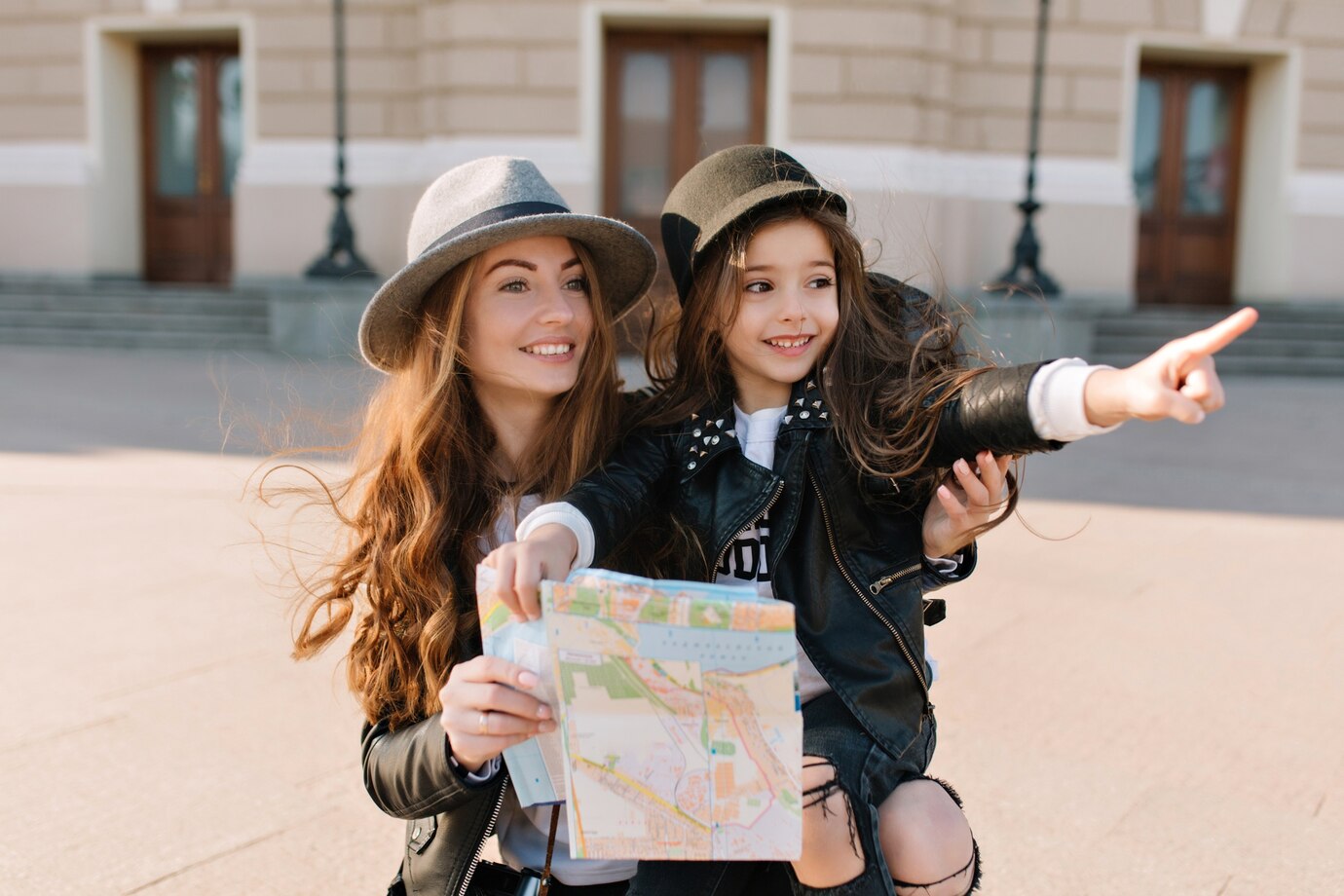 portrait_of_adorable_little_girl_in_trendy_hat_pointing_with_finger.jpg