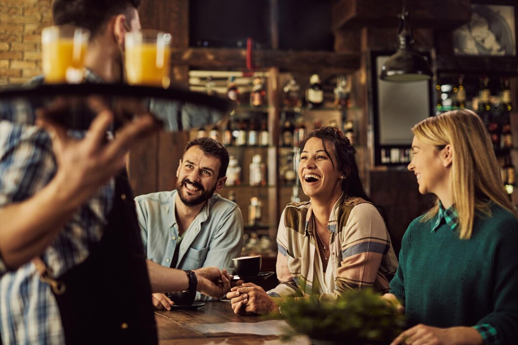 cheerful-friends-having-fun-while-talking-waiter-cafe_637285-12509.jpg