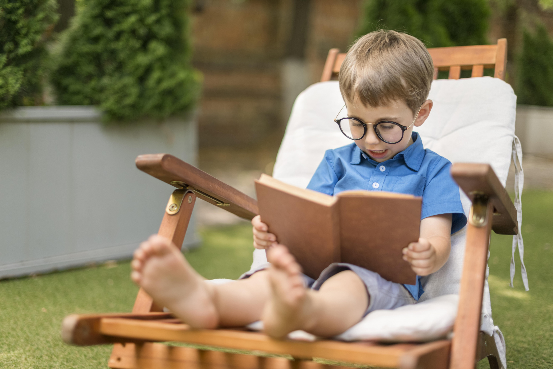 little-boy-reading-while-sitting-outside.jpg little-boy-reading-while-sitting-outside.jpg