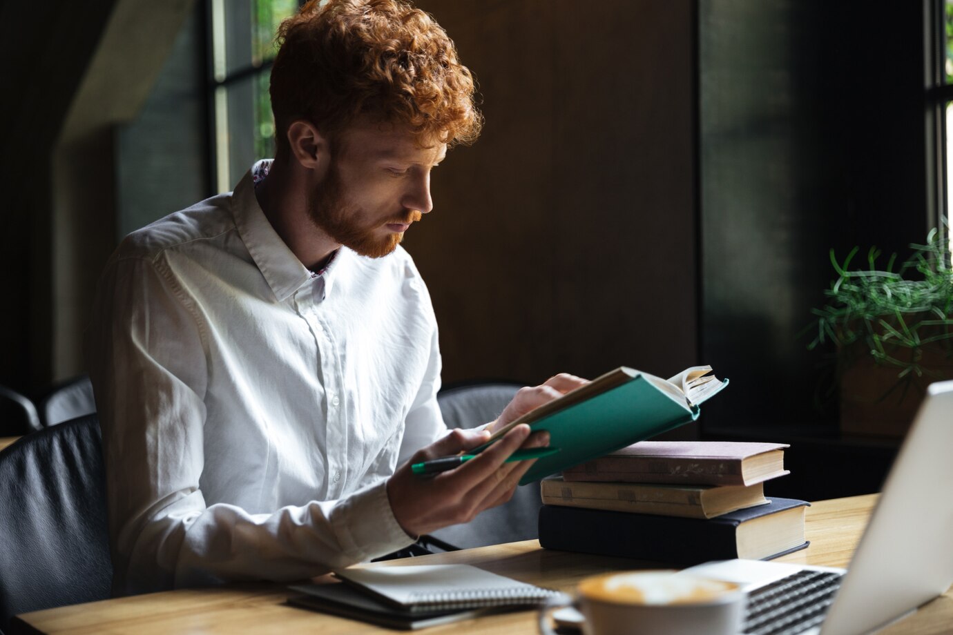 photo_of_concentrated_redhead_bearded_student_preparing_for_university.jpg